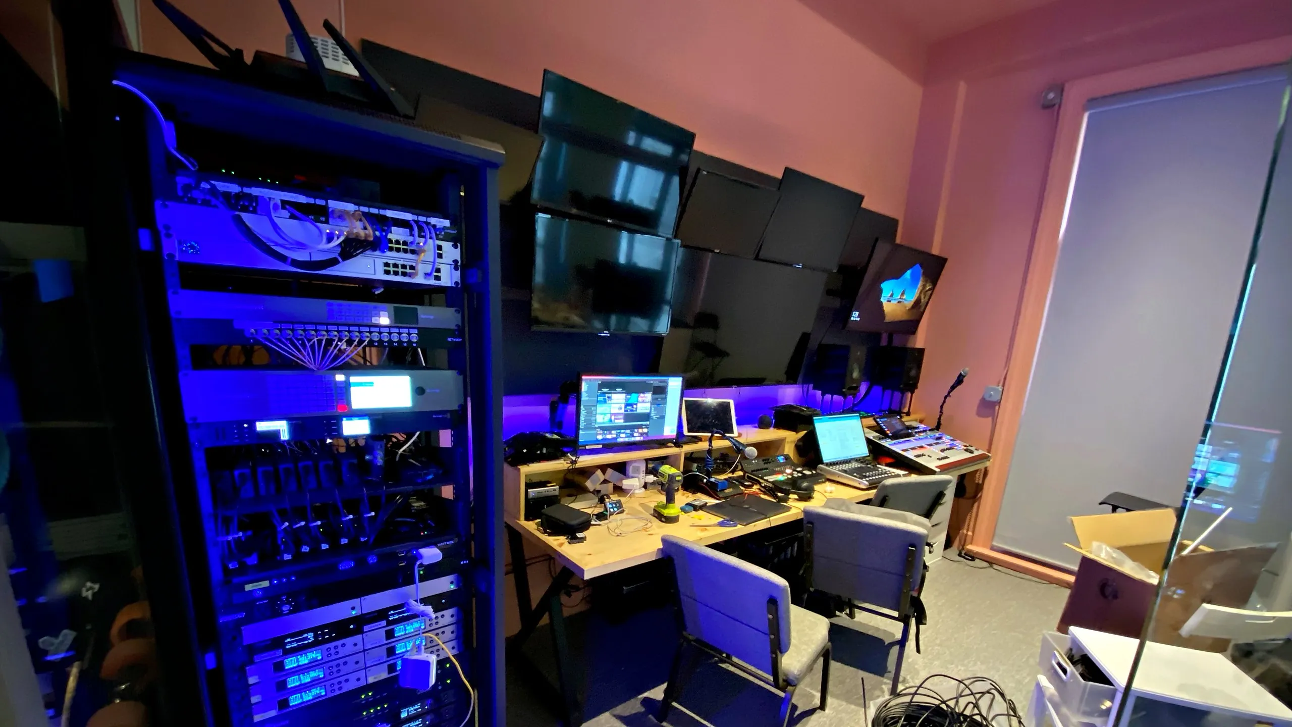 AV control room with an equipment rack and operator desk